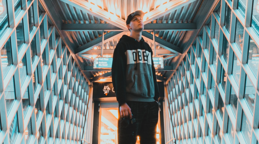 Young man standing in a futuristic-looking building.