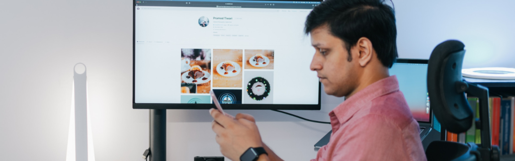 Man in front of a computer monitor with CAD images on screen.