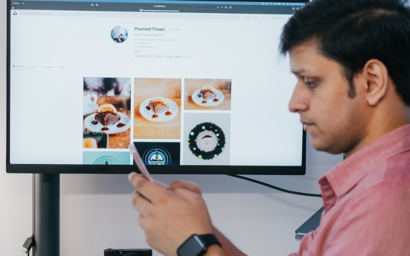 Man in front of a computer monitor with CAD images on screen.