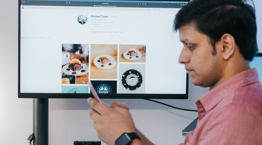 Man in front of a computer monitor with CAD images on screen.